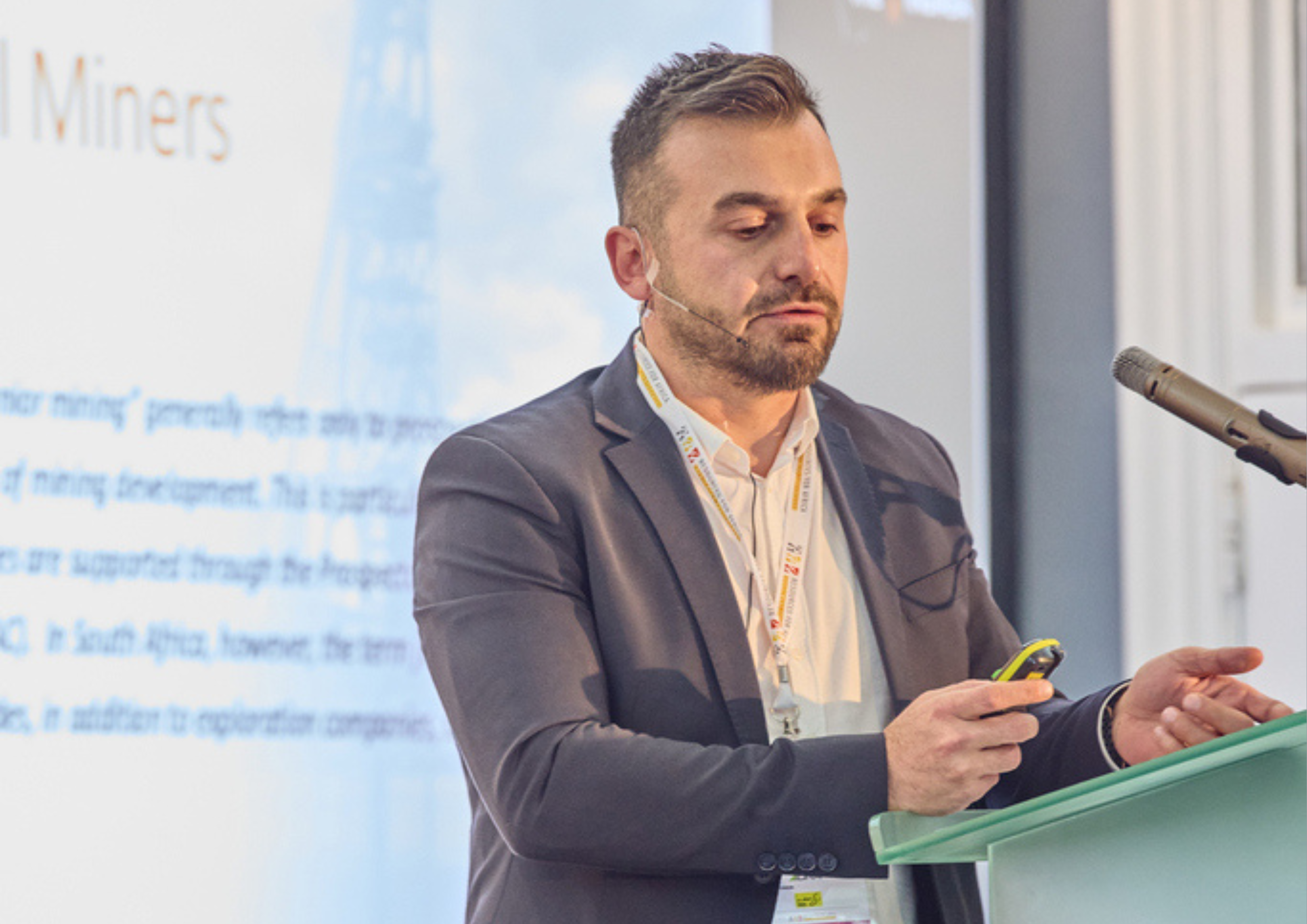 An image of a male on stage presenting at a Junior Indaba Conference 2024